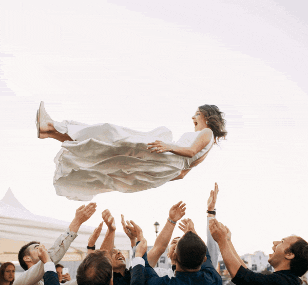 woman trusting men throwing her up in the air
