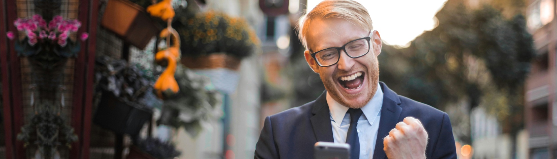 man happy about a deal on his phone