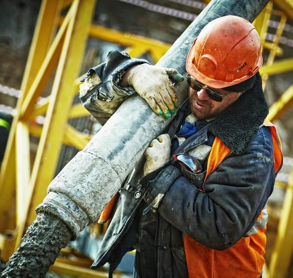 rig hand directing an effluent pipe