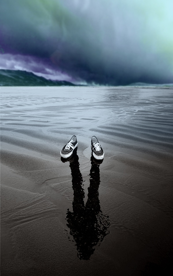 absent on the beach with reflection in the sand